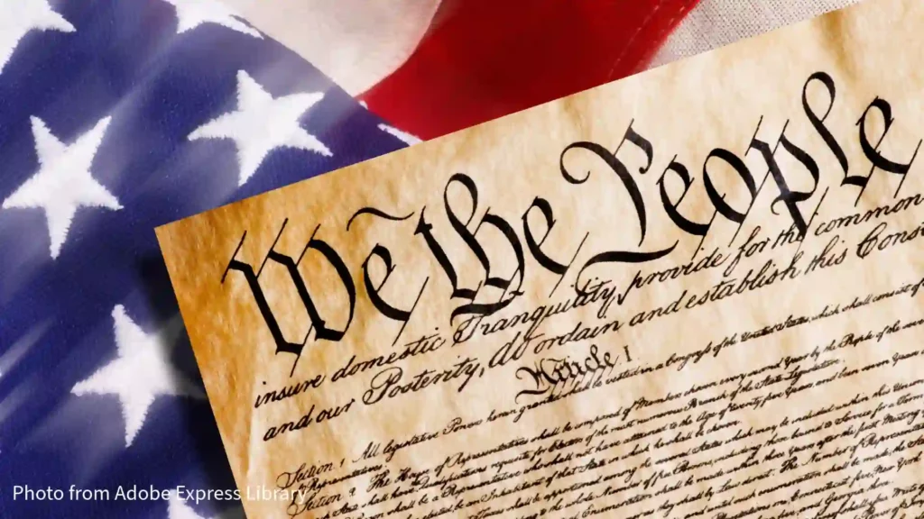 top of declaration of independence at an angle sitting on top of american flag